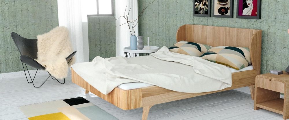 Ein Designermassivholzbett in einem grünen Raum